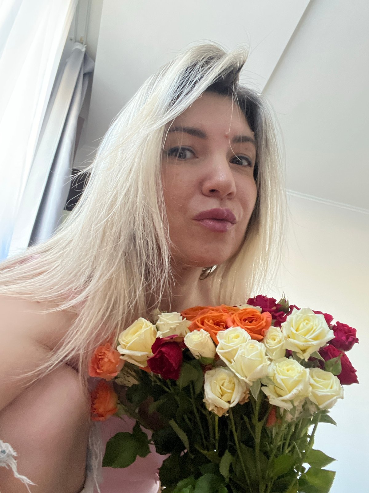 Woman documents flower-filled afternoon with pet dog in Sochi