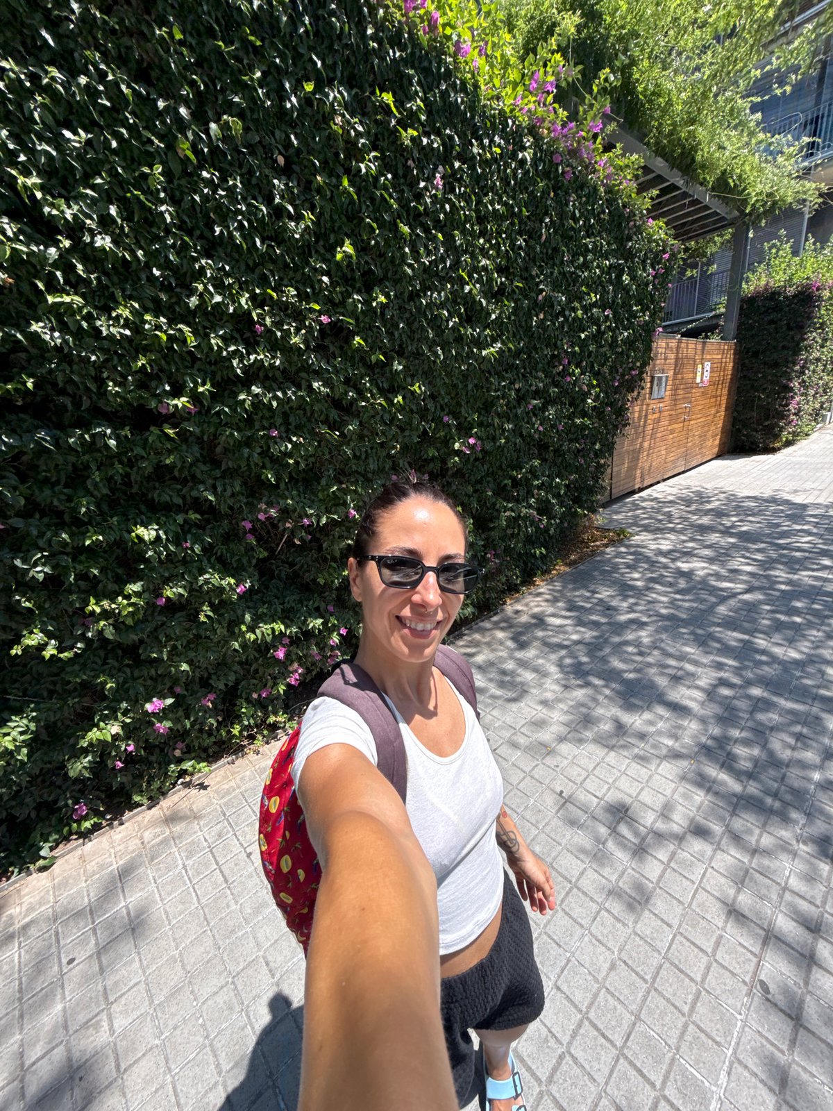 Noon stroll past Barcelona's glass towers and flowering walls.