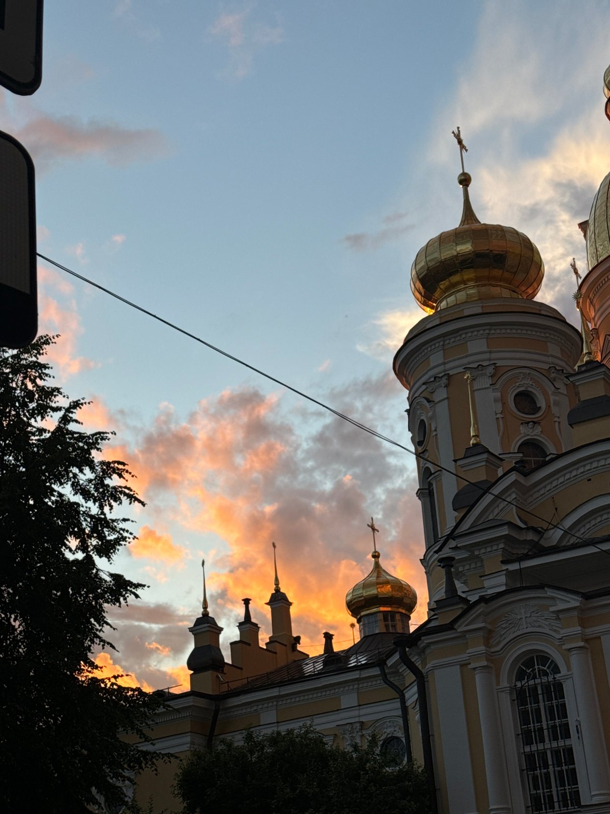 Double rainbow and golden-hour sky over Saint Petersburg