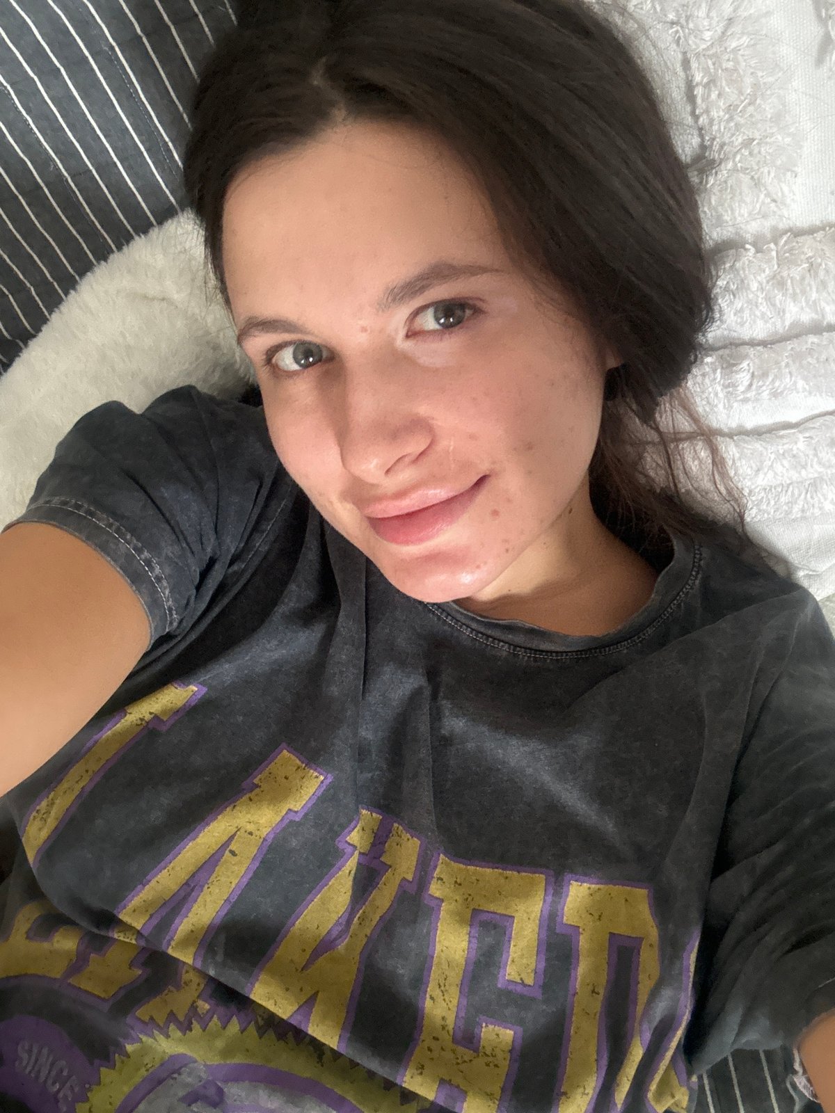 Woman resting on bed observed in Akulovo, Russia