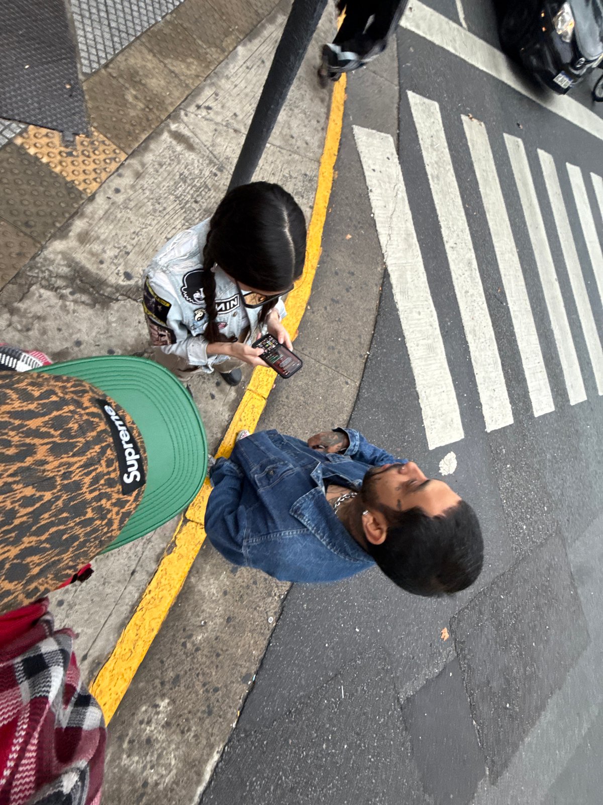 Evening pedestrians navigate wet Buenos Aires intersection