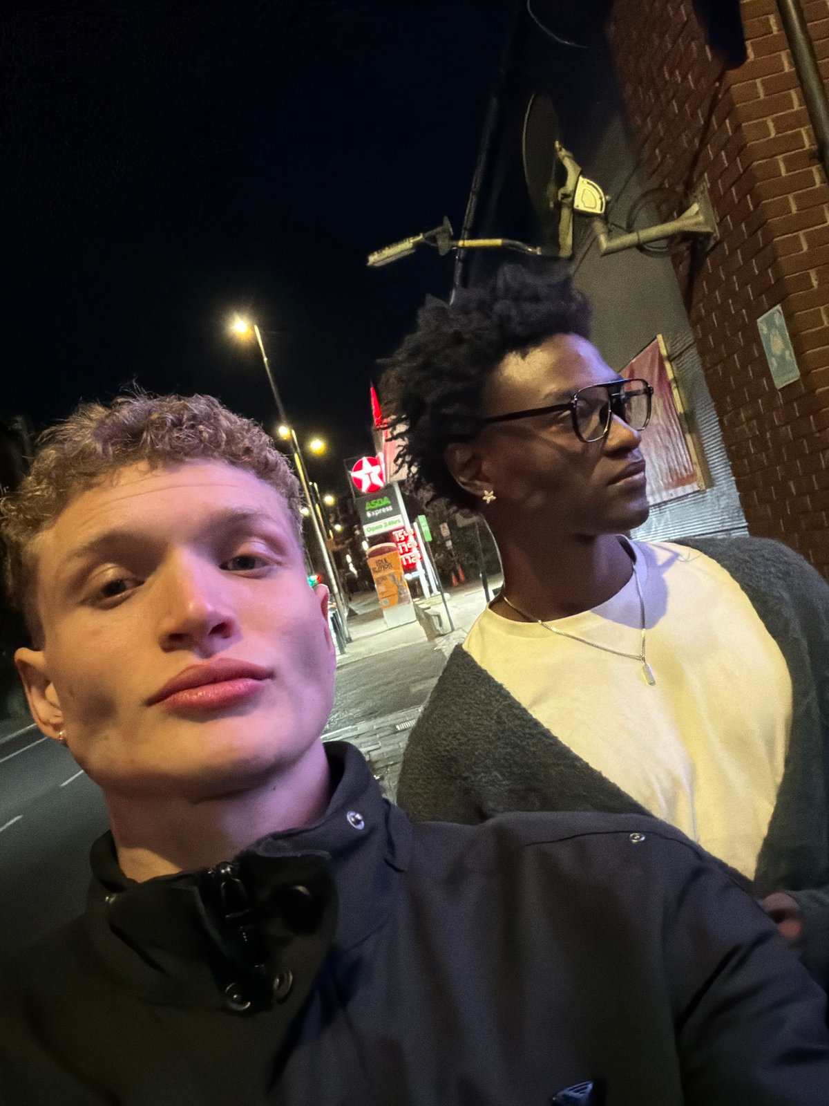 Selfie taken at London Texaco station with luxury cars