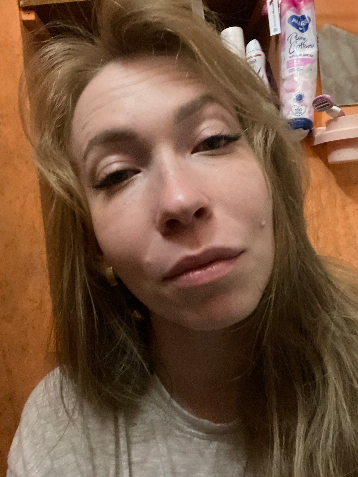 Woman takes selfies with jeweled phone in Perm apartment