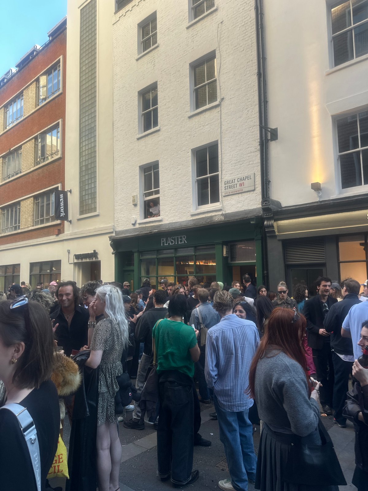 Crowds gather for evening drinks on London's Great Chapel Street