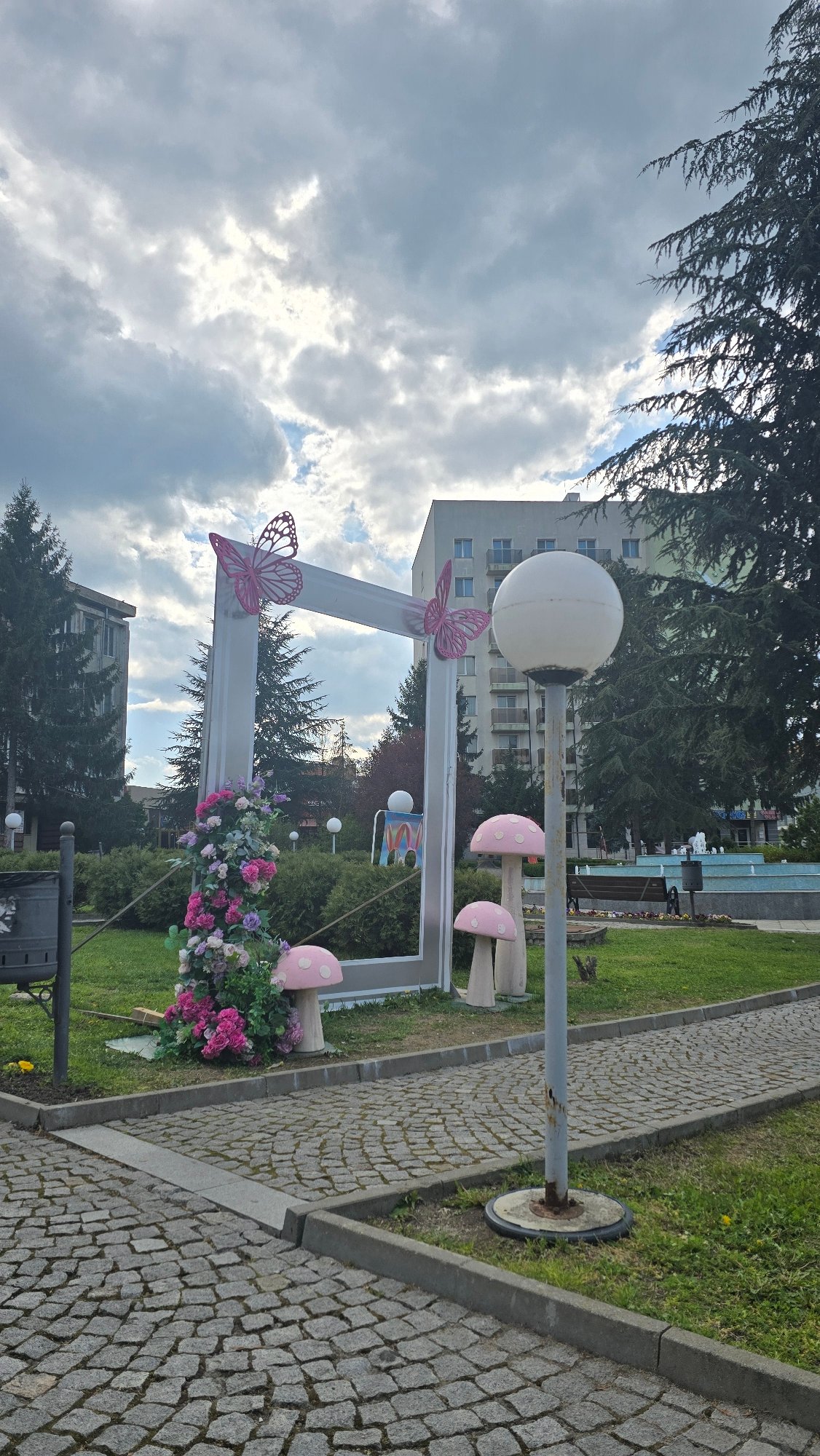 Woman enjoys milkshake selfie in decorated Elhovo park