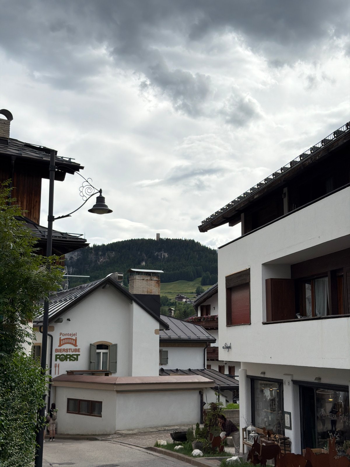 Afternoon in an Alpine town — streets, scaffolding, and mountain views