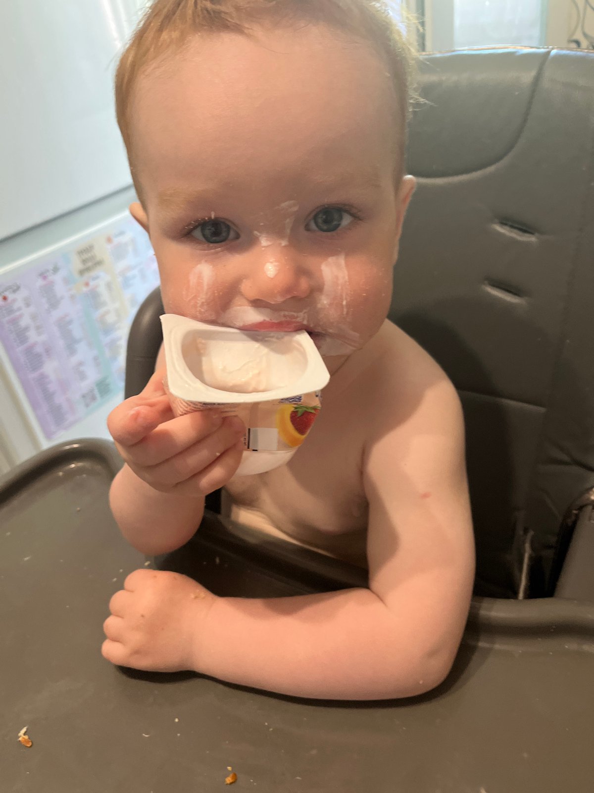 Woman with flowers, baby eating yogurt captured in Chaikovsky