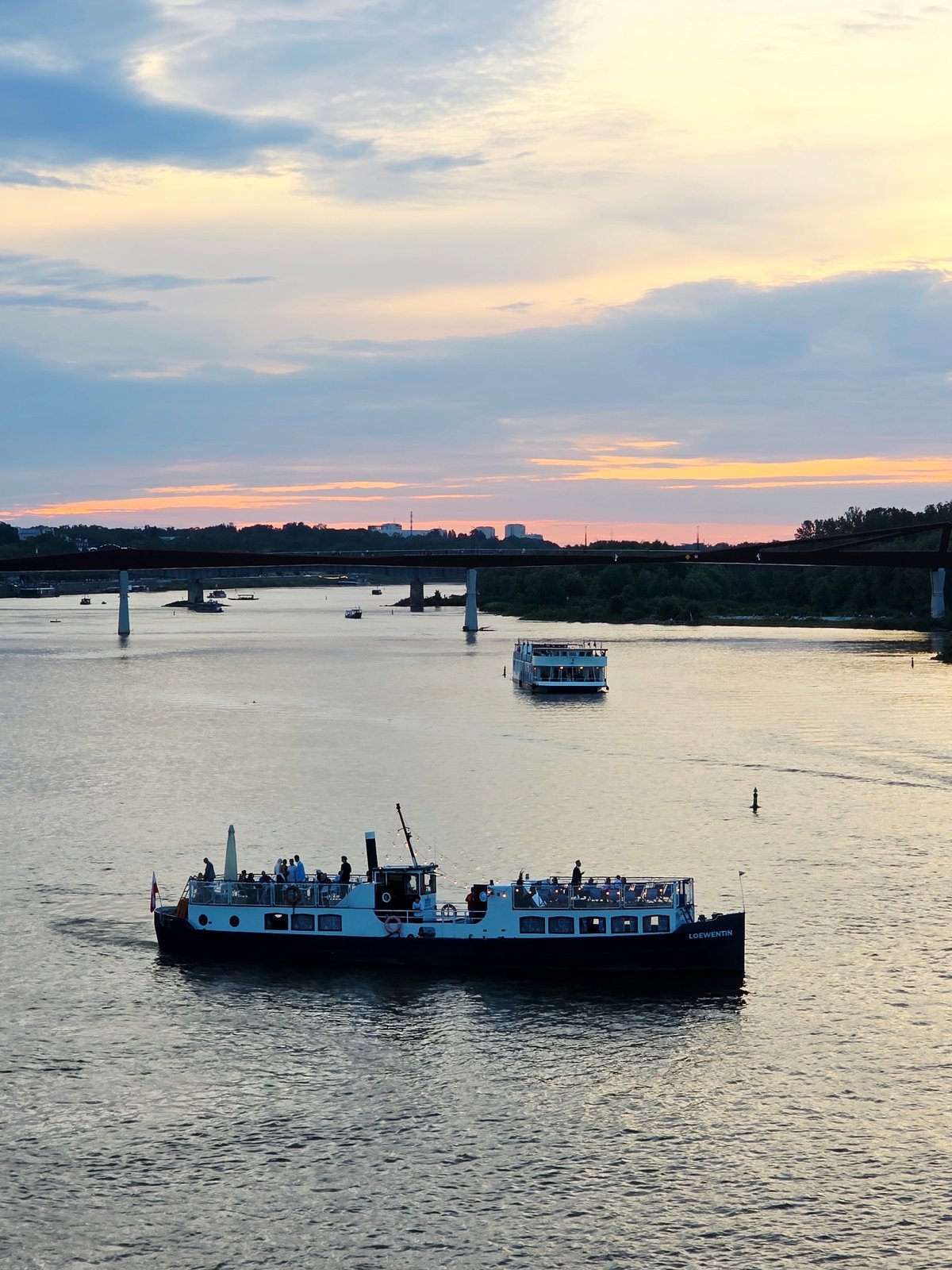 Warsaw's Vistula riverfront at golden hour, busy and alive