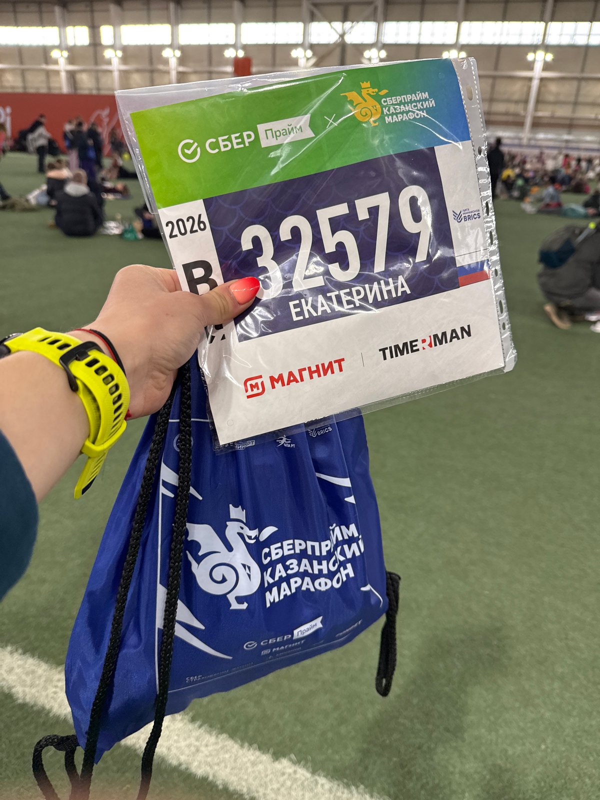 Runner holds race bib at indoor sporting event