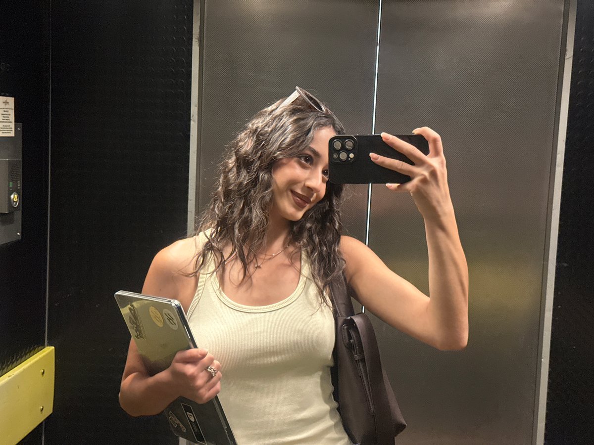 Woman Takes Selfies While Carrying Laptop in Milan