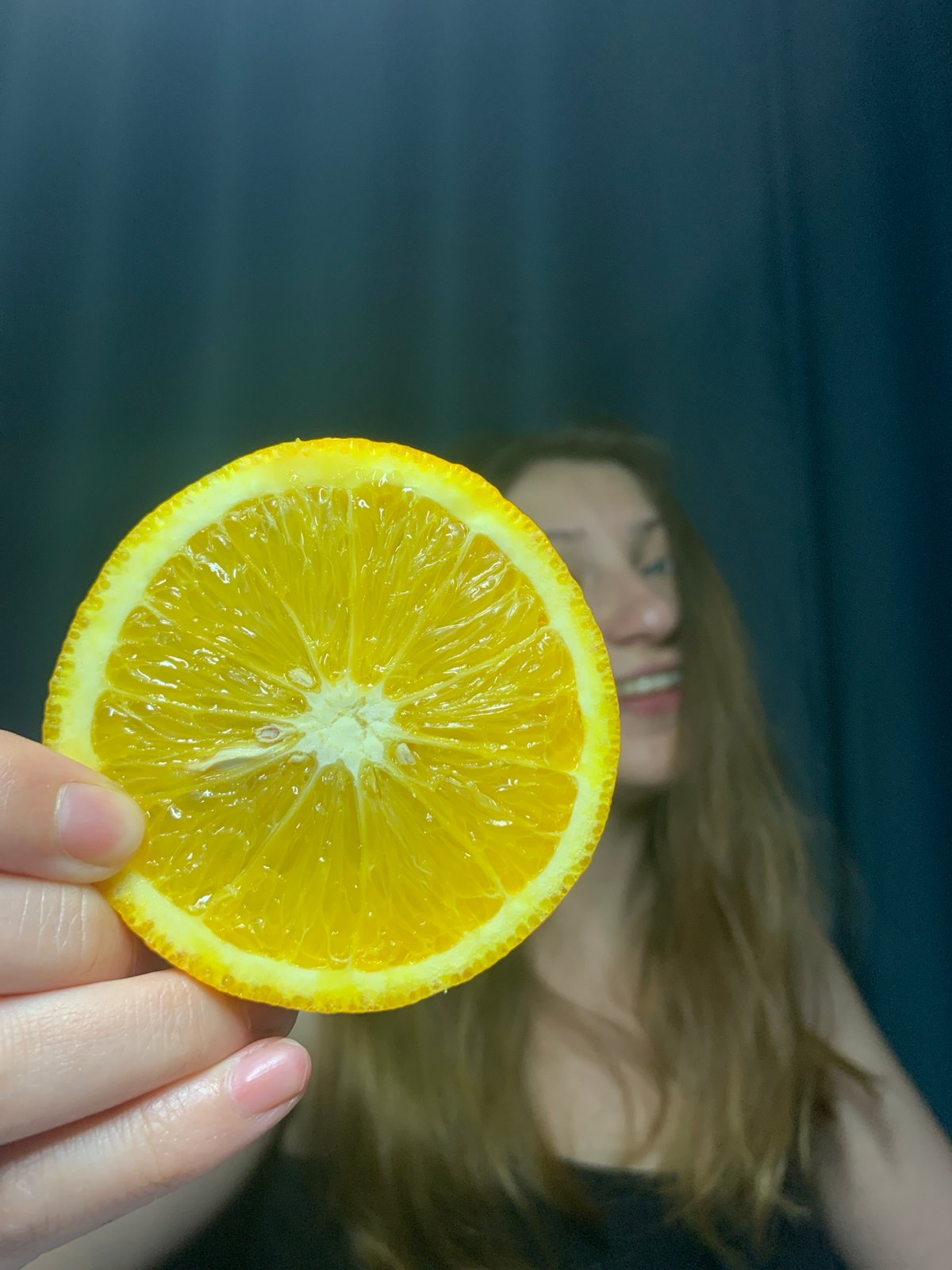 Woman photographed in various poses with oranges in Chaikovsky