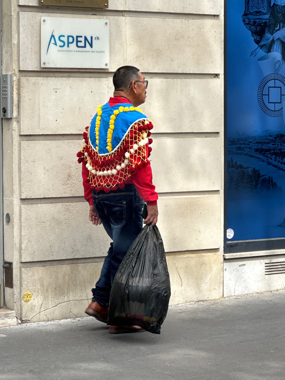 Street life outside a red glass building in Paris