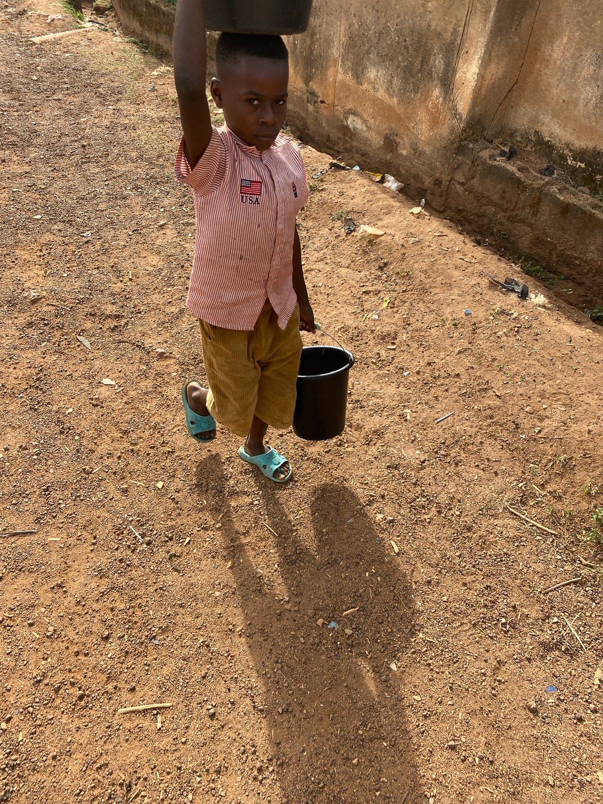 Children and dog captured in everyday Bukuru neighborhood scene
