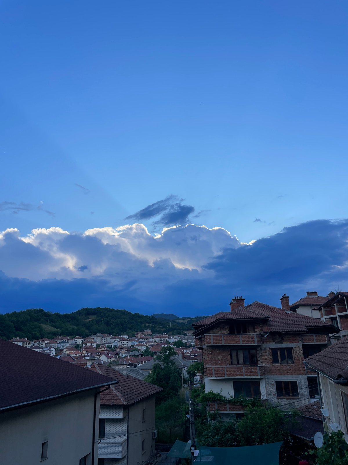 Zlatograd hillside town under a shifting late-afternoon sky