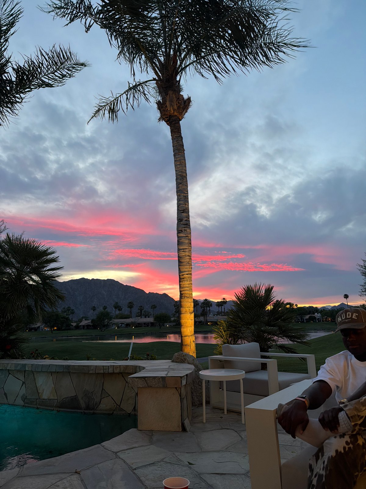 Evening sunset captured over La Quinta mountains with palm tree