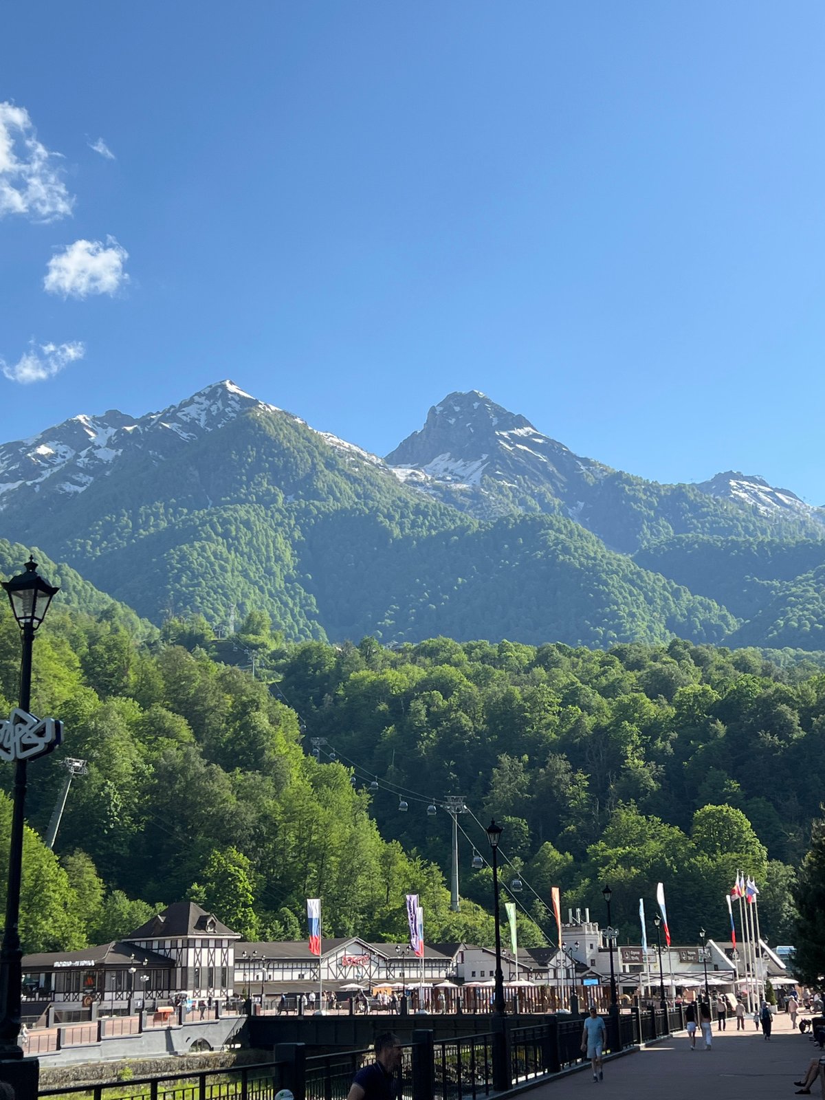 Tourist documents scenic mountain resort with sculptures in Estosadok