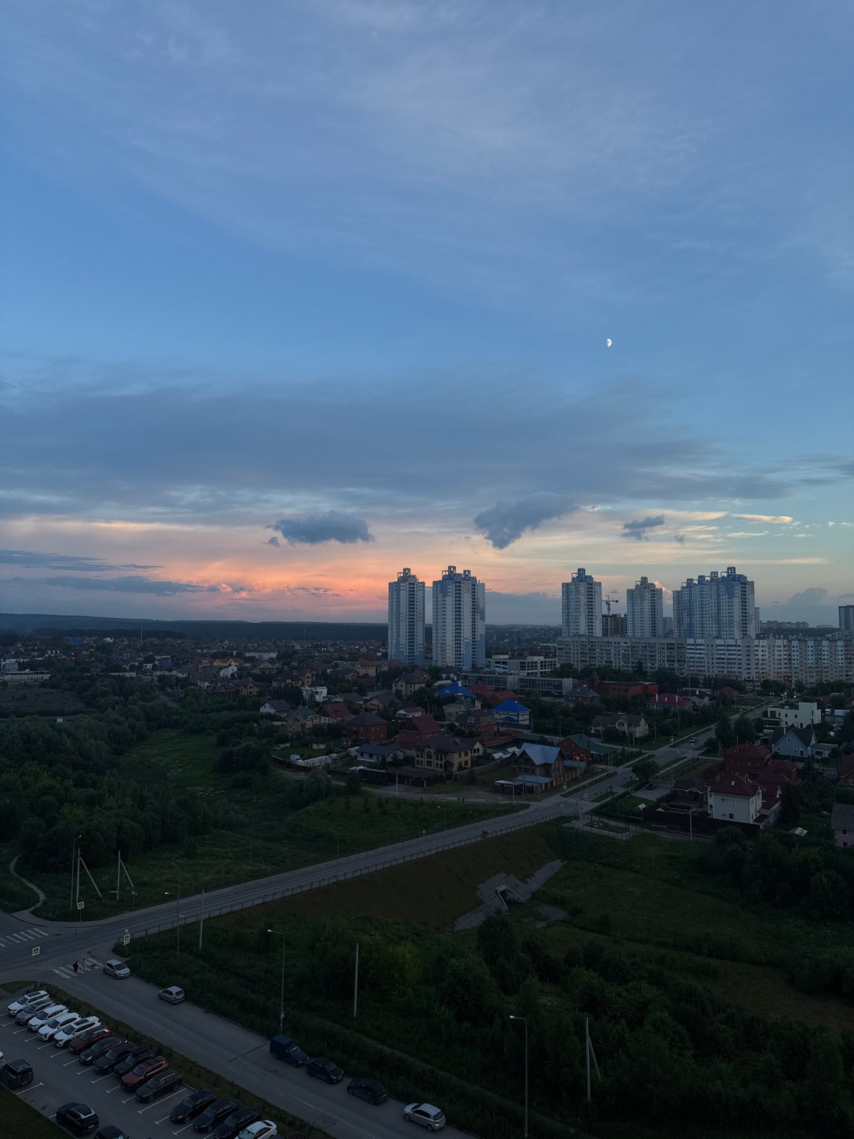 Drone survey of Perm at golden hour, crescent moon rising