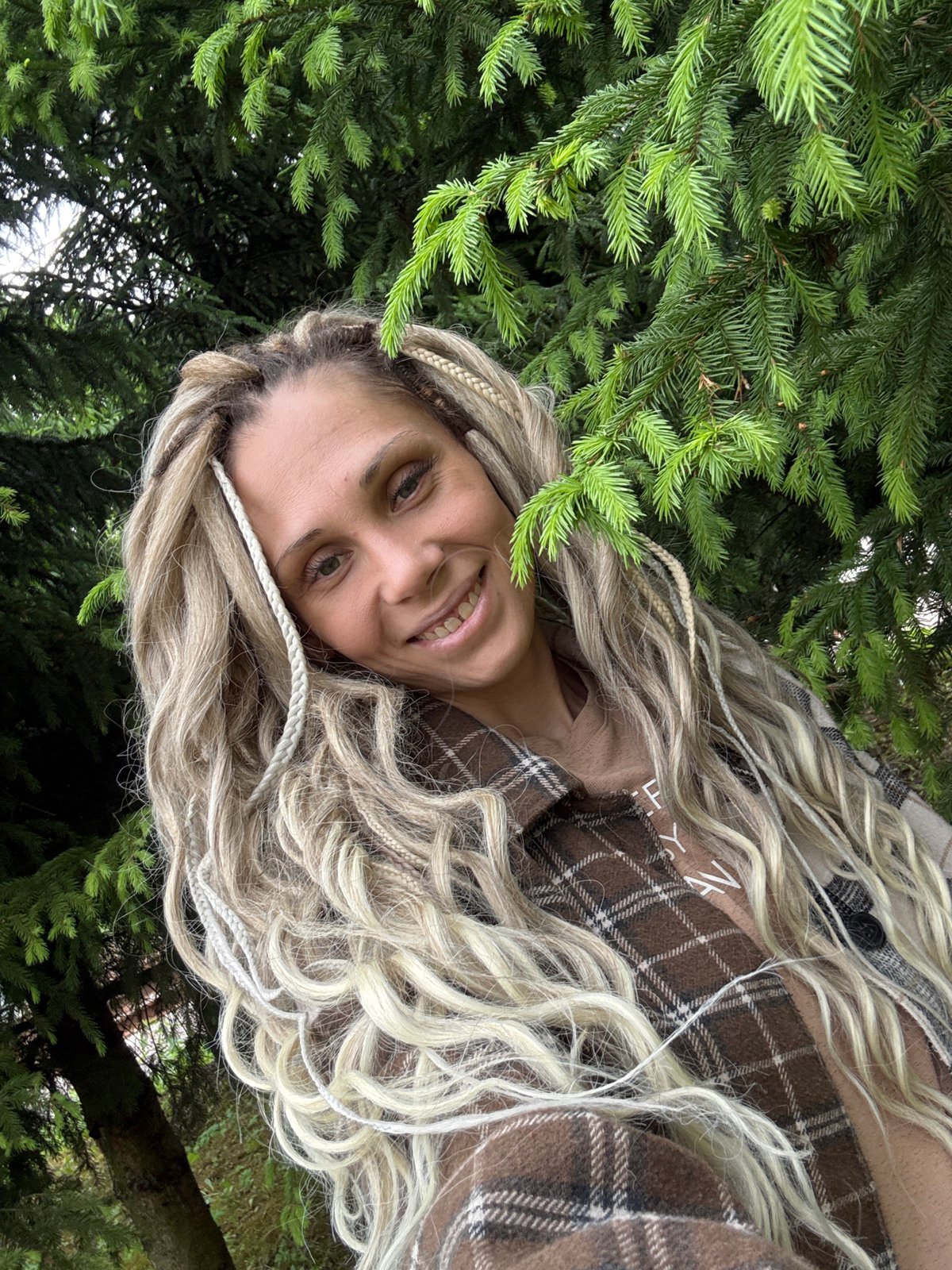 Woman photographed smiling in wooded area near Rusanovo, Russia