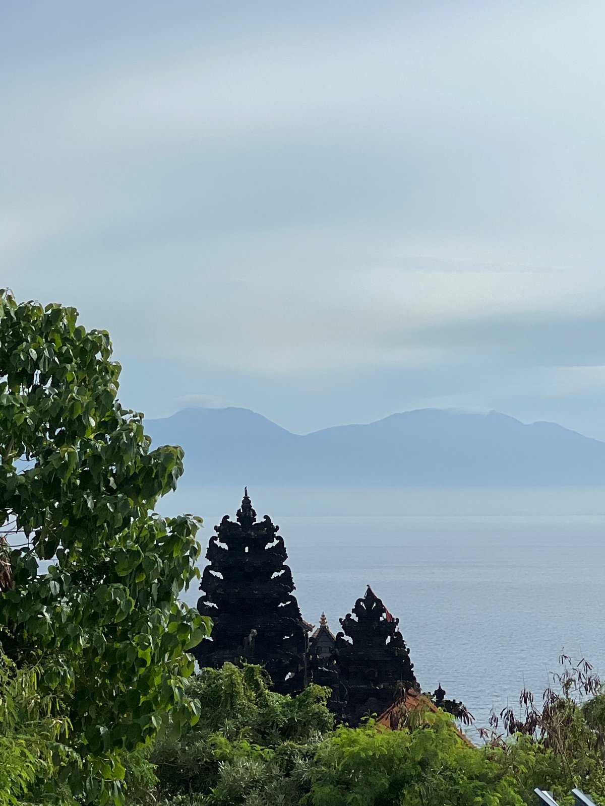 Temple silhouette observed on Kuta Selatan clifftop at dawn