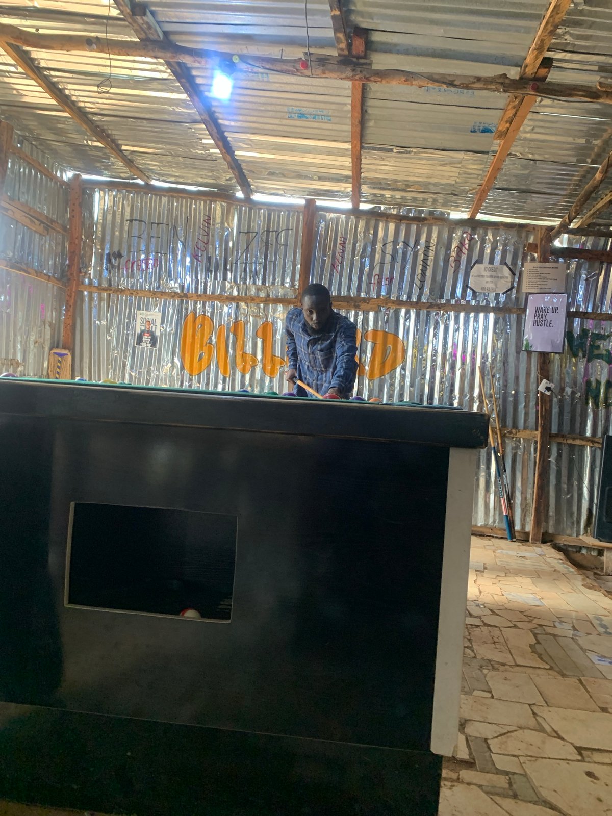 Daily life documented in Nigerian communities: pool games, housing