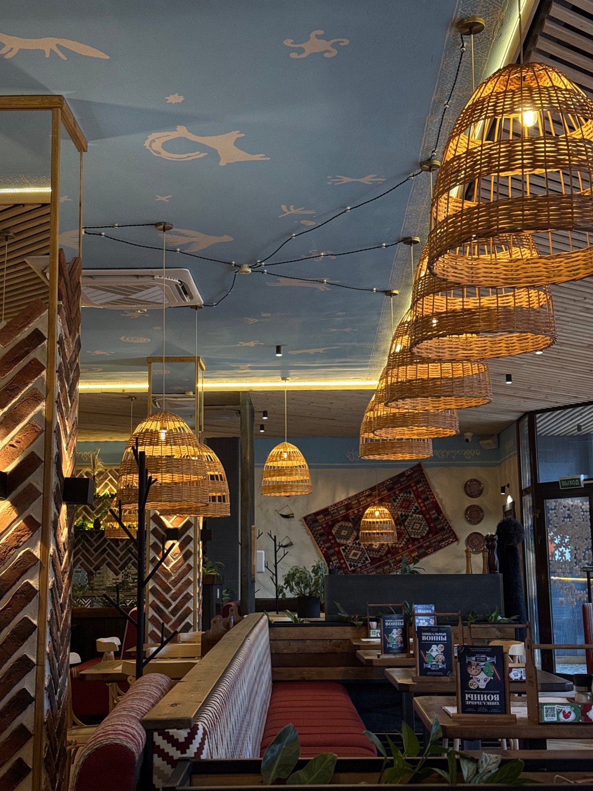 Rustic cafe interior with woven lamps, Mikhaylovsk, Russia