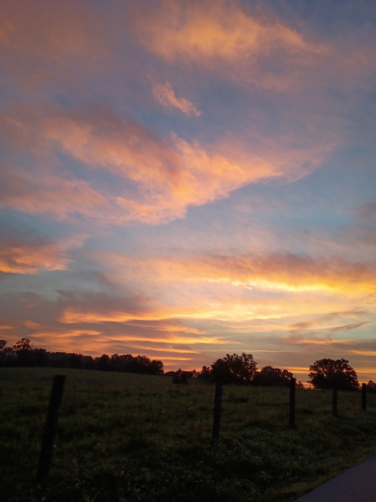 Colorful dusk sky over rural fields near Versailles, Kentucky
