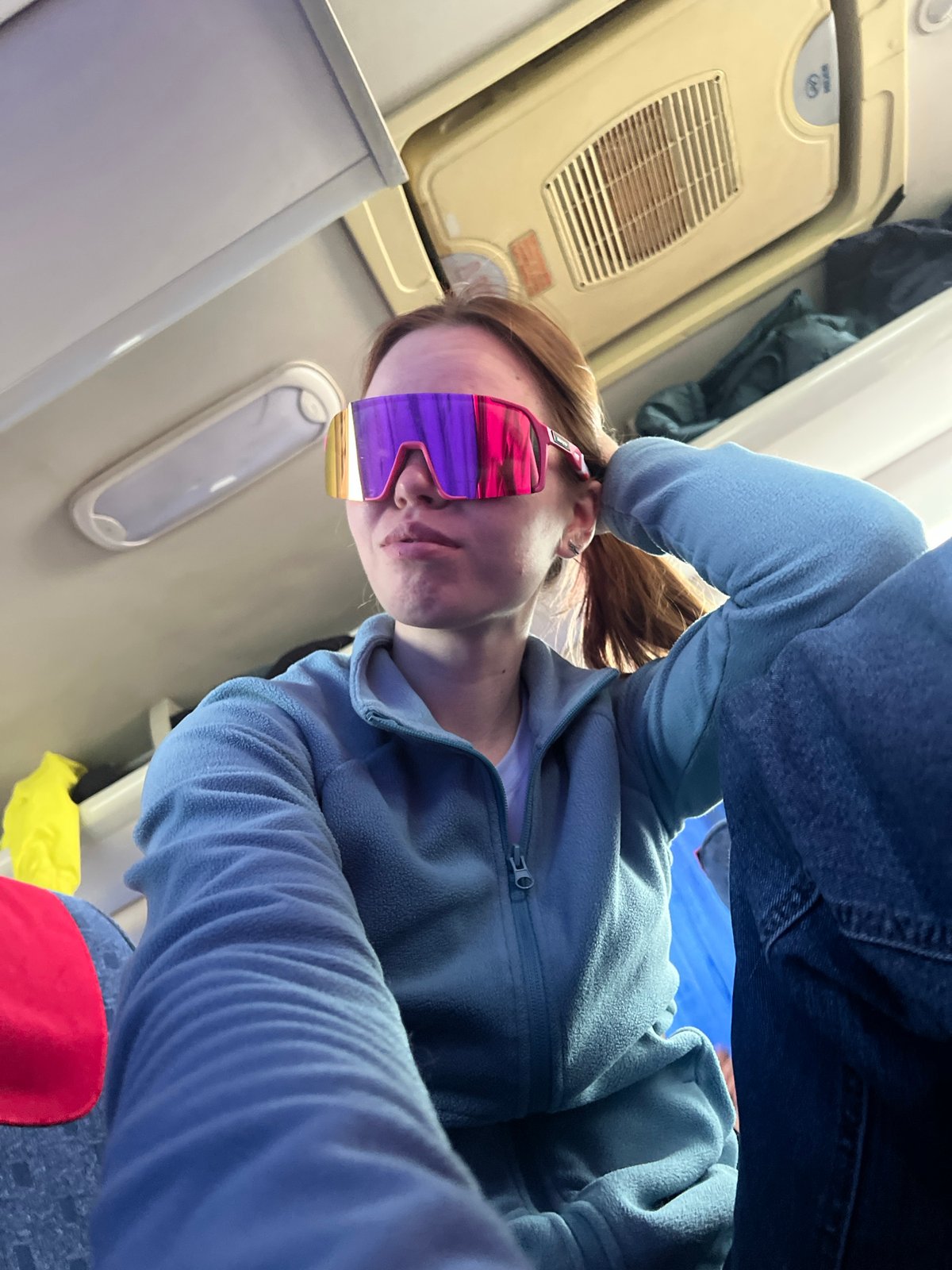 Woman in purple sunglasses observed on flight near Russia