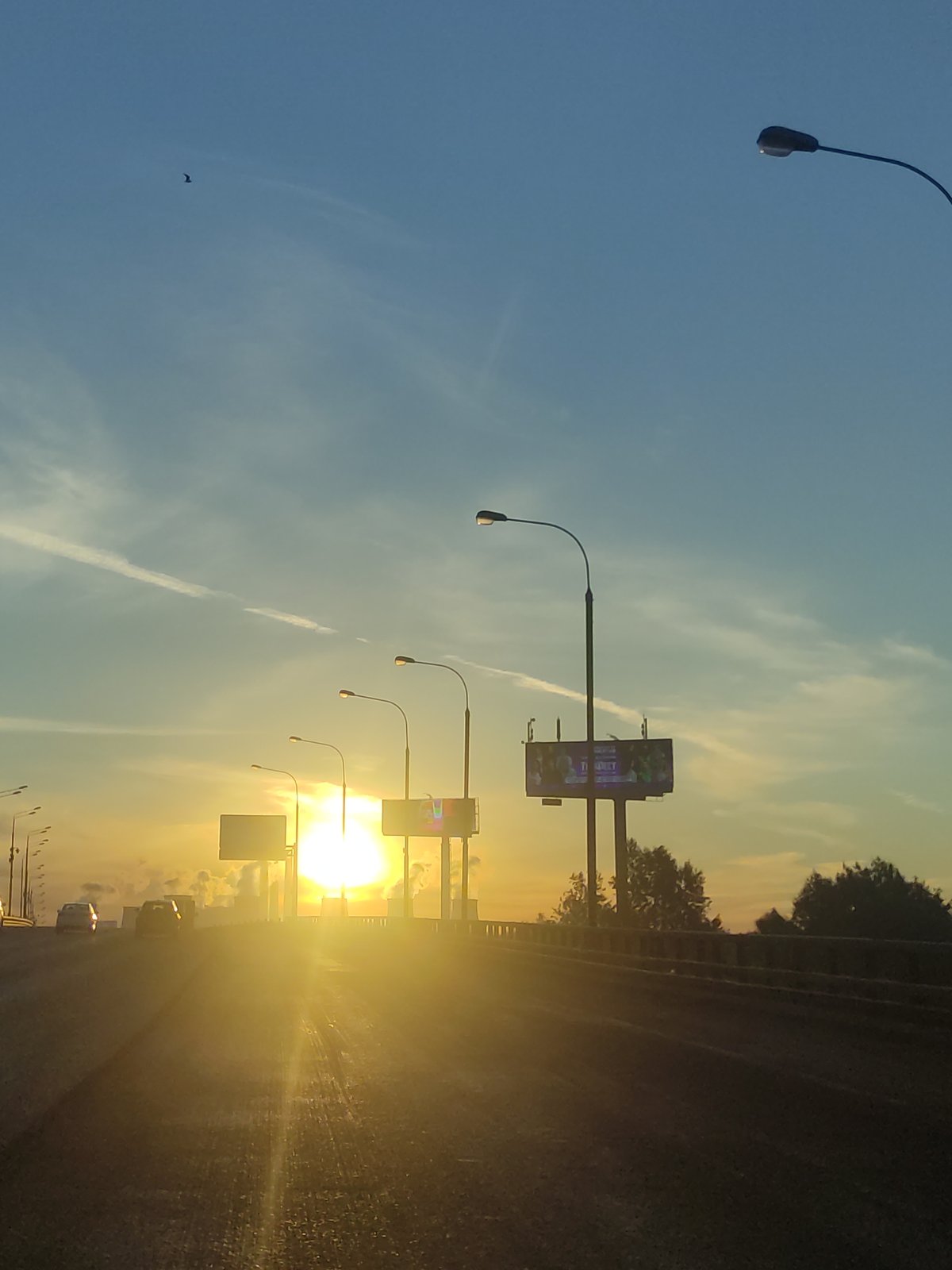 Dramatic sunrise or sunset documented on multi-lane highway