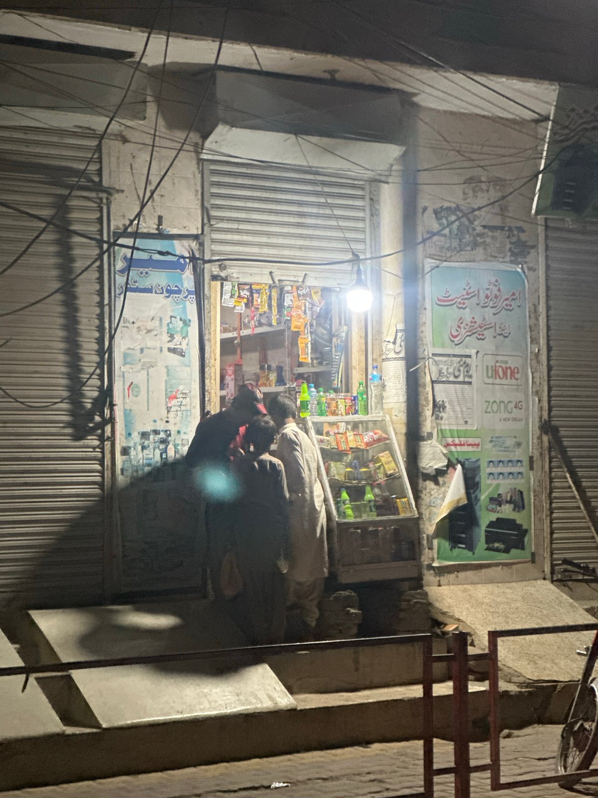Brightly lit shop remains open amid shuttered neighbors
