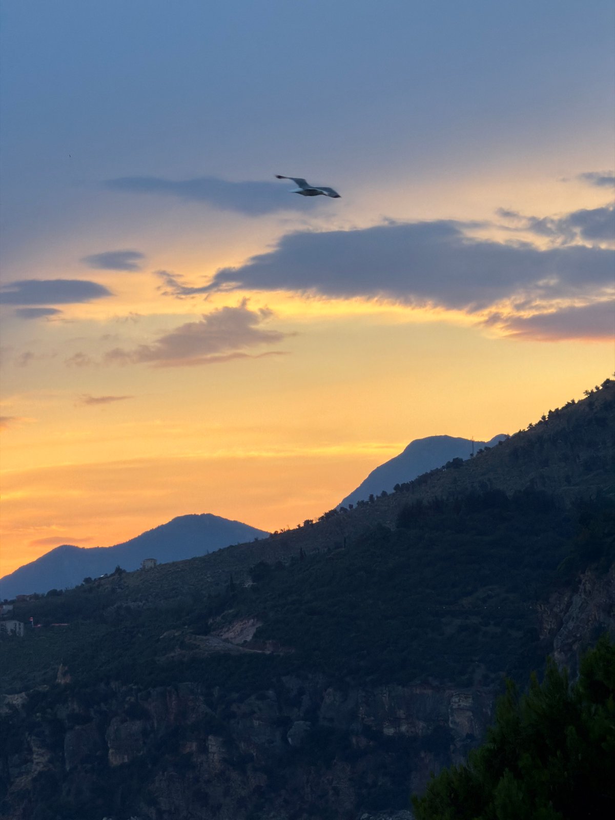 Petrovac na Moru coastline at golden hour, storm clouds rolling in
