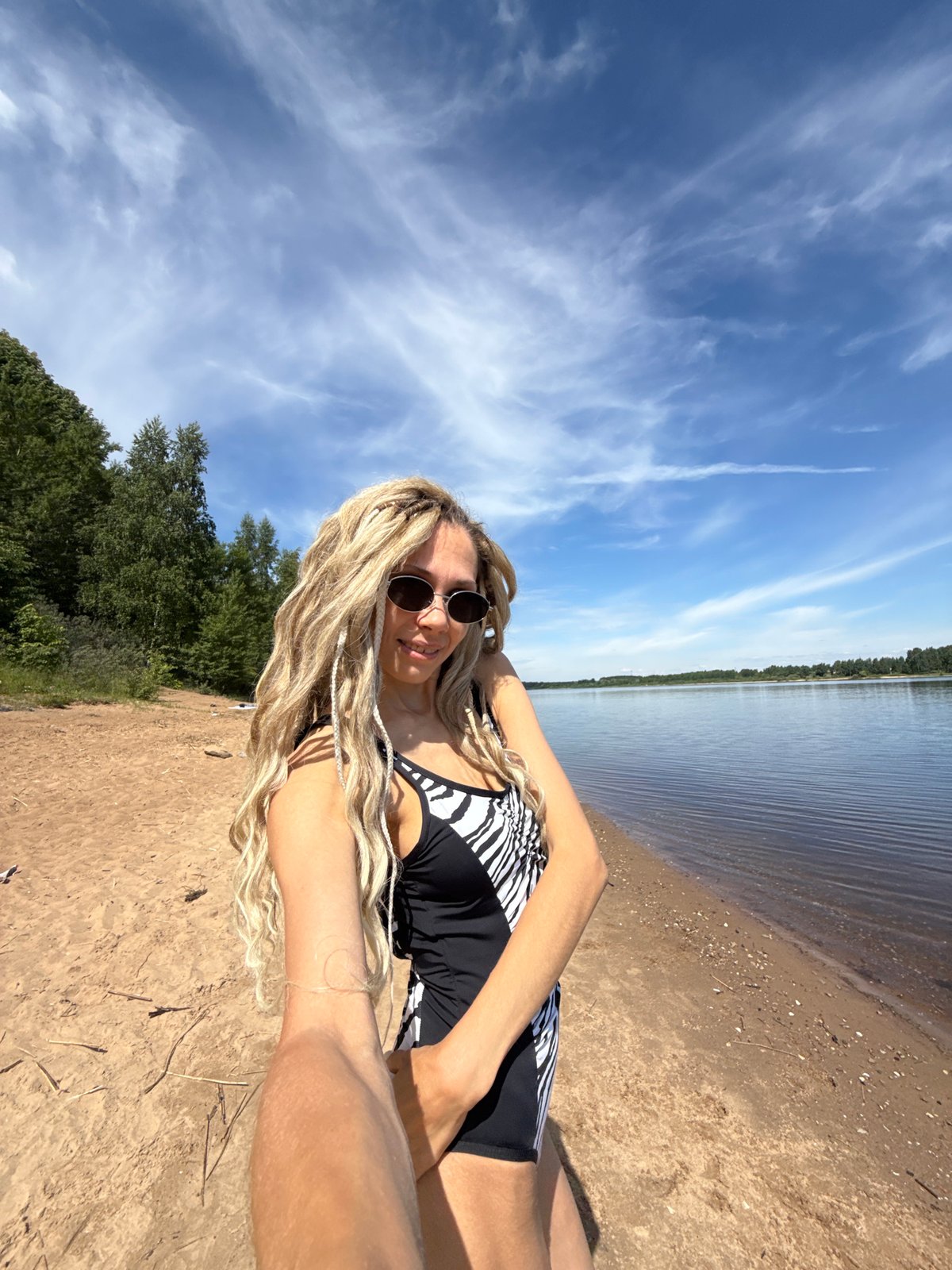 Woman enjoys morning beach time in Rusanovo, Russia