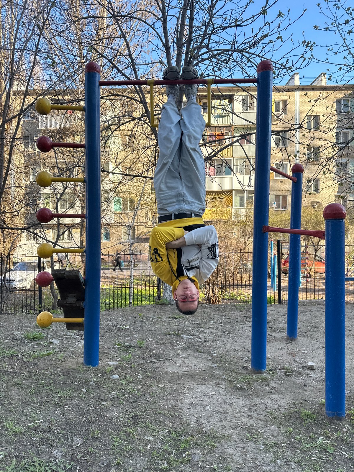 Young man exercises on playground equipment in Saratov