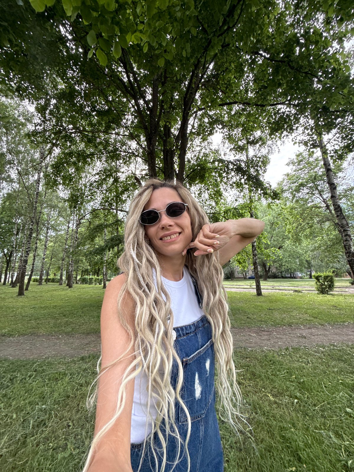 Woman poses for outdoor photo session in Russian village park