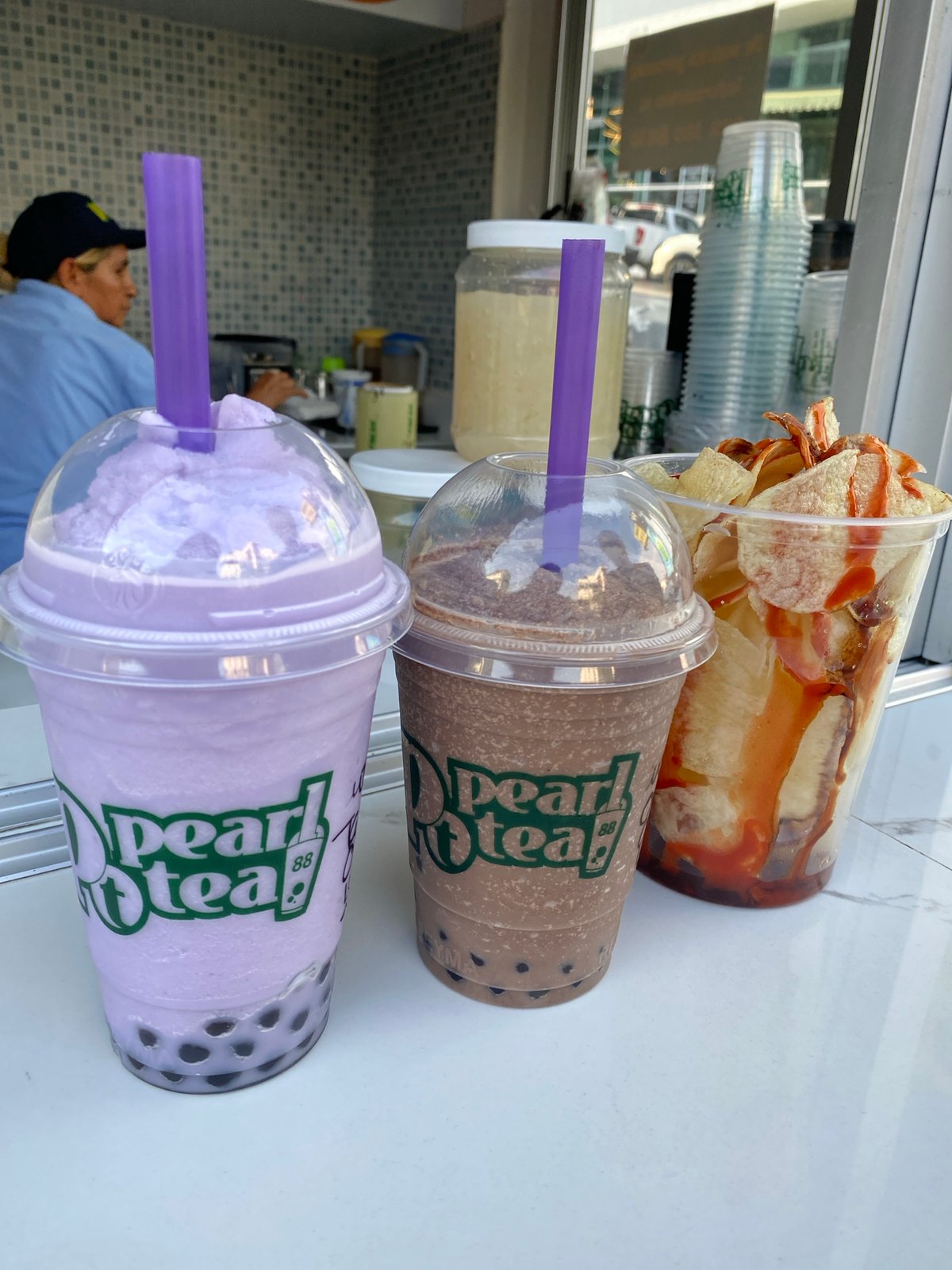 Urban evening captures boba tea, World Cup stickers, convenience shopping