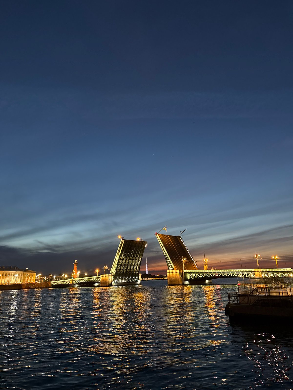Palace Bridge raises drawbridge spans during nighttime in Saint Petersburg