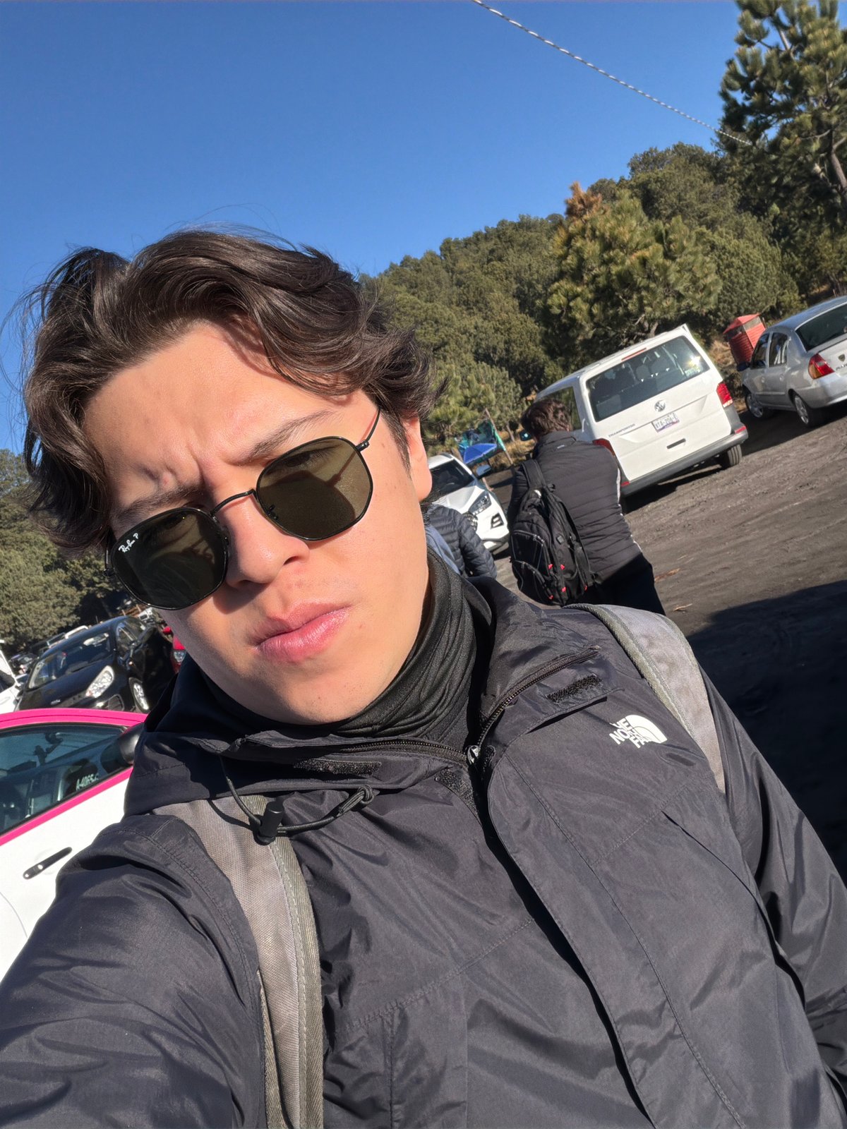 Tourist takes selfies in mountain parking lot near Tlamacas