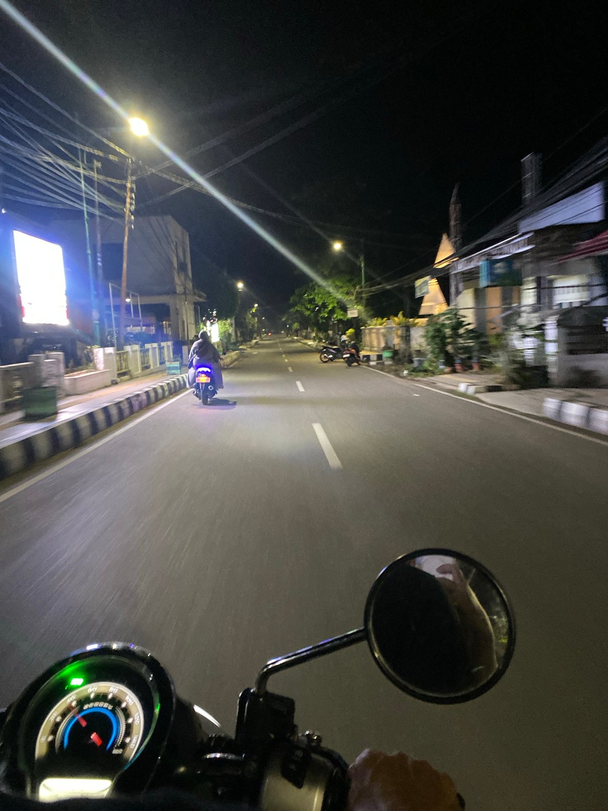 Nighttime motorcycle traffic documented on Tanjung road