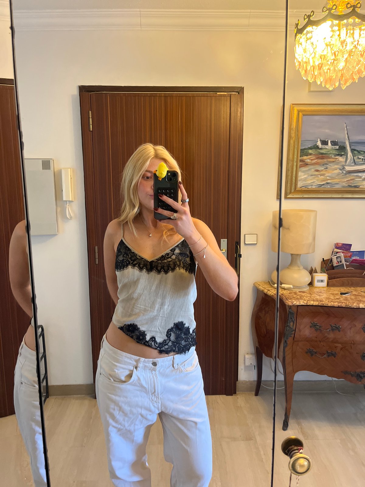Woman Takes Mirror Selfie with Yellow Duck Phone Accessory