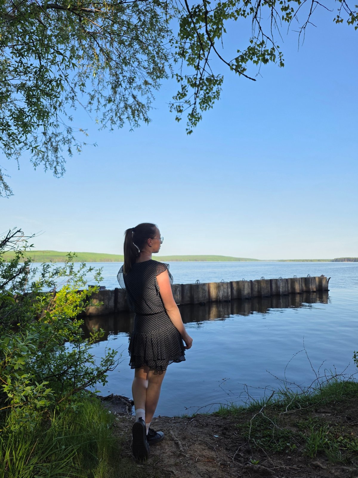 Woman spends afternoon exploring waterfront park in Chaikovsky, Russia