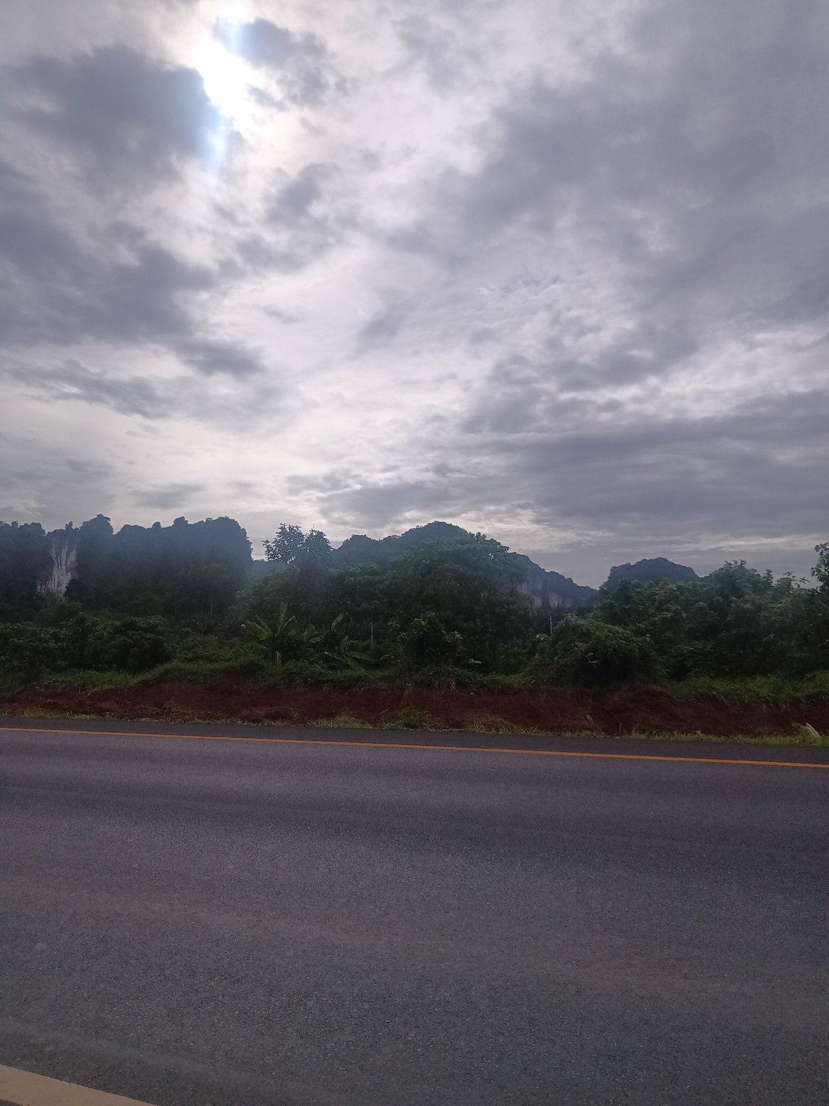 Tourist documents scenic mountain drive through Plai Phraya, Thailand