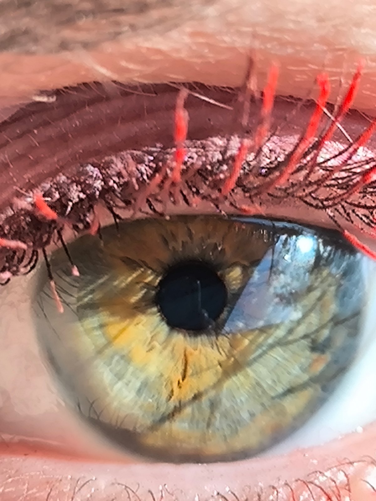 Close-up eye photograph with red makeup captured in Riga