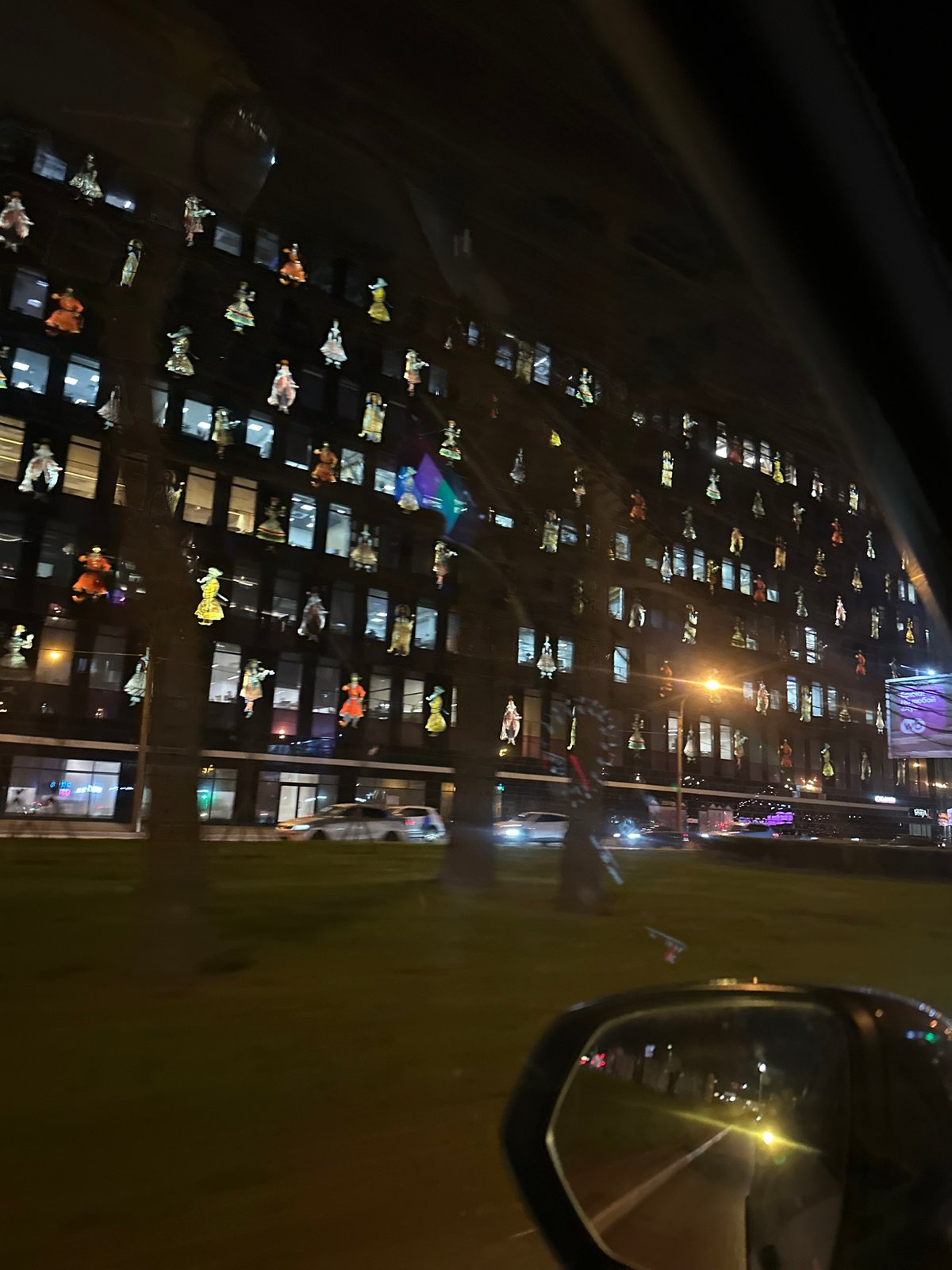 Decorated building photographed from car at night in Saint Petersburg