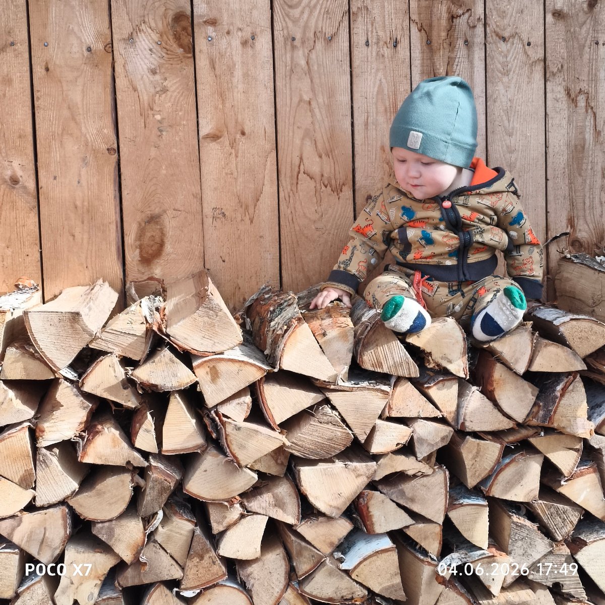 Family moments captured around firewood stacks in Chaikovsky, Russia