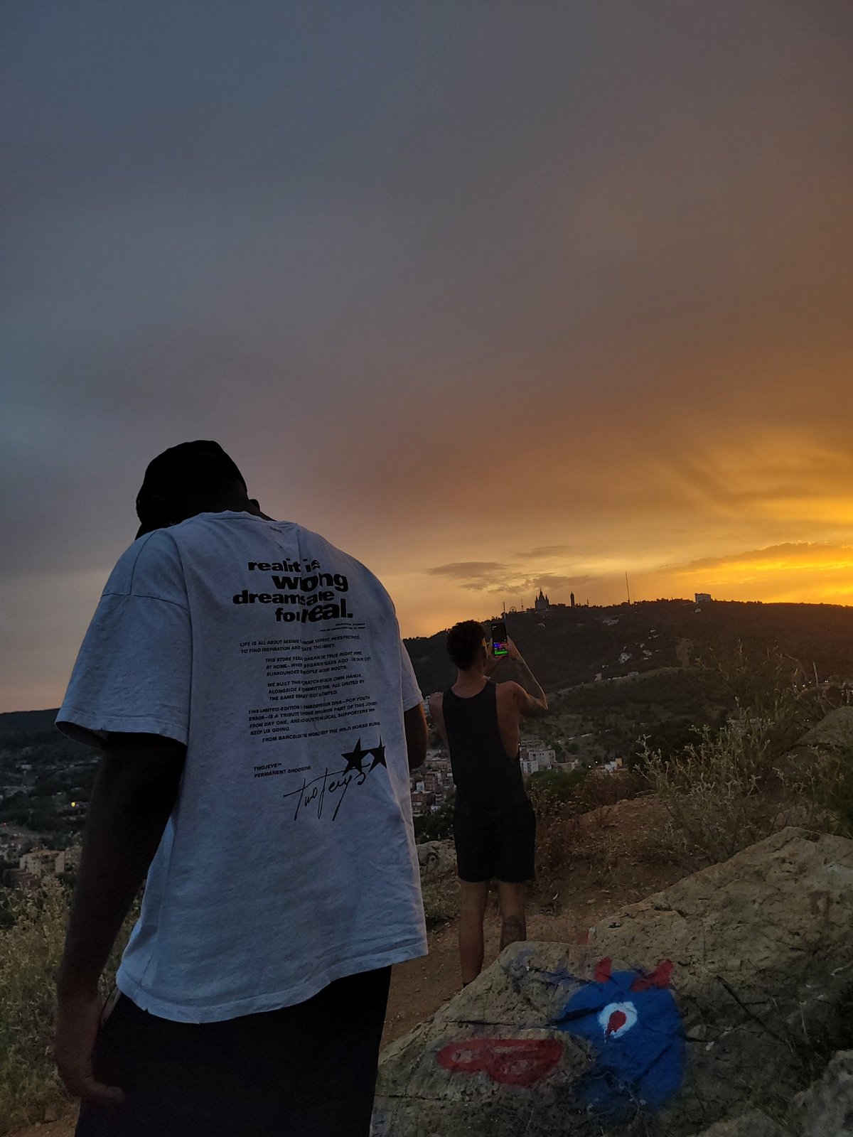 Sunset photographers gather at city overlook cliff