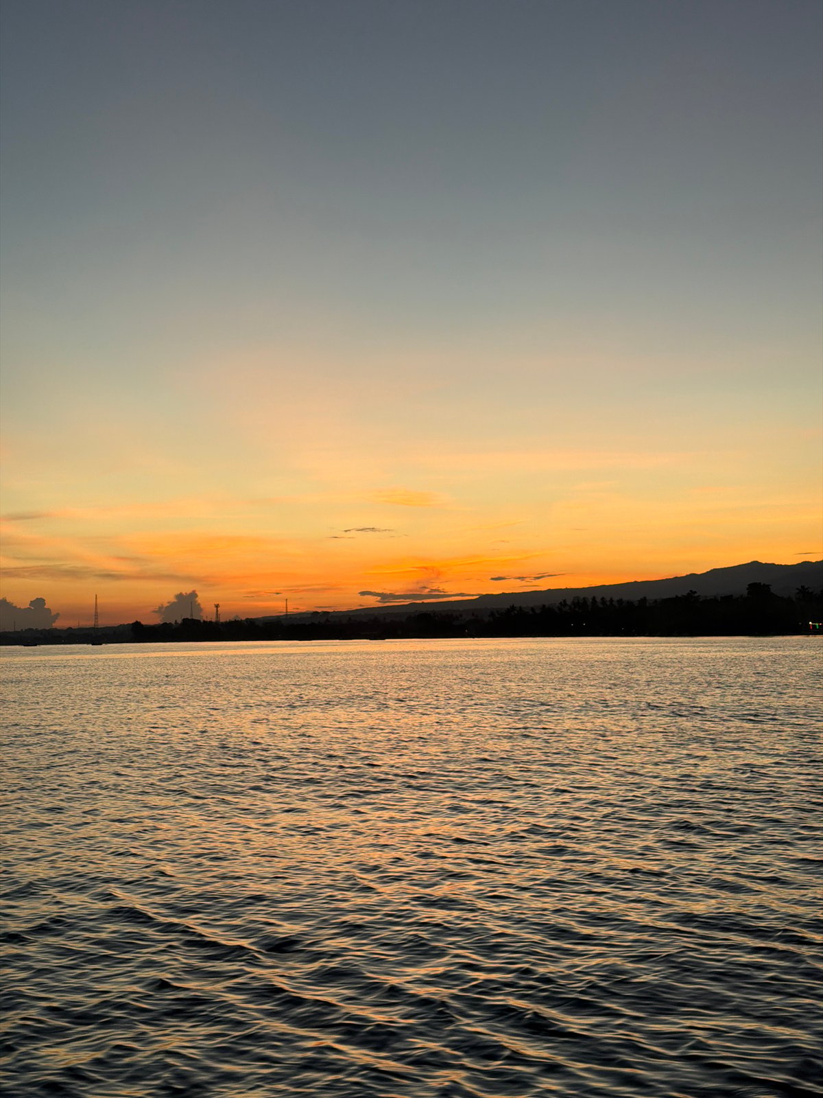 Dusk reflection captured on water in Kalibukbuk, Indonesia