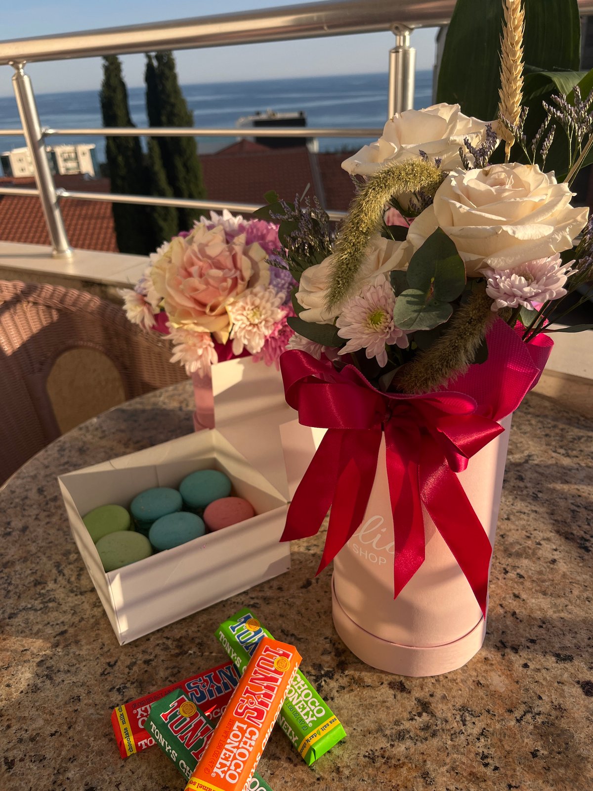 Celebration setup with flowers, macarons captured on Montenegro coast