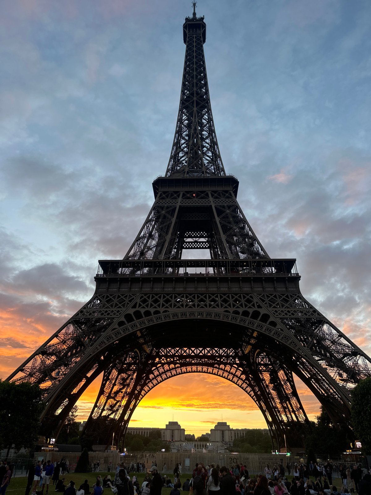 Crowds gather at Eiffel Tower for dramatic sunset viewing