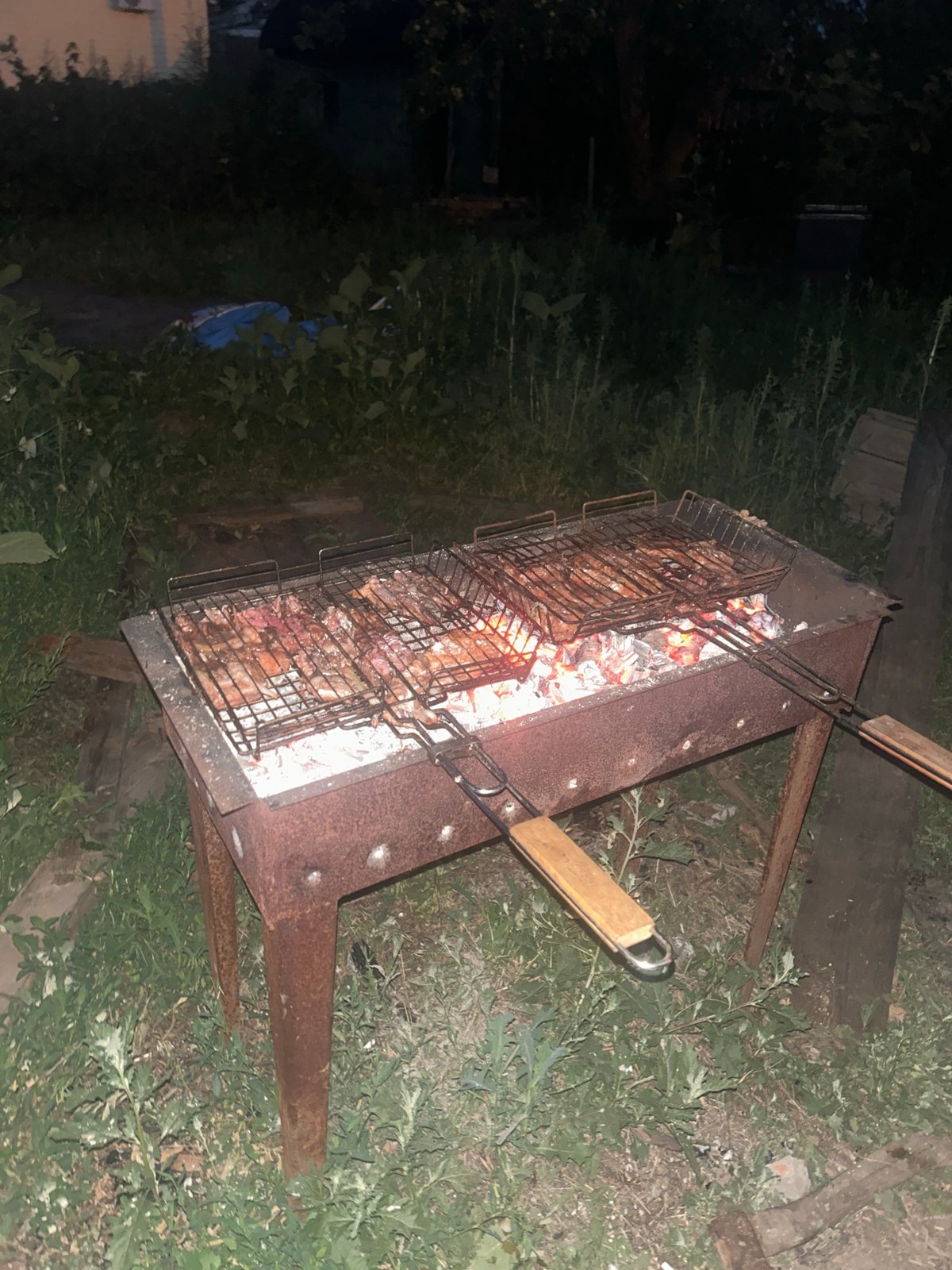 Backyard grill session at dusk in Engels, Russia