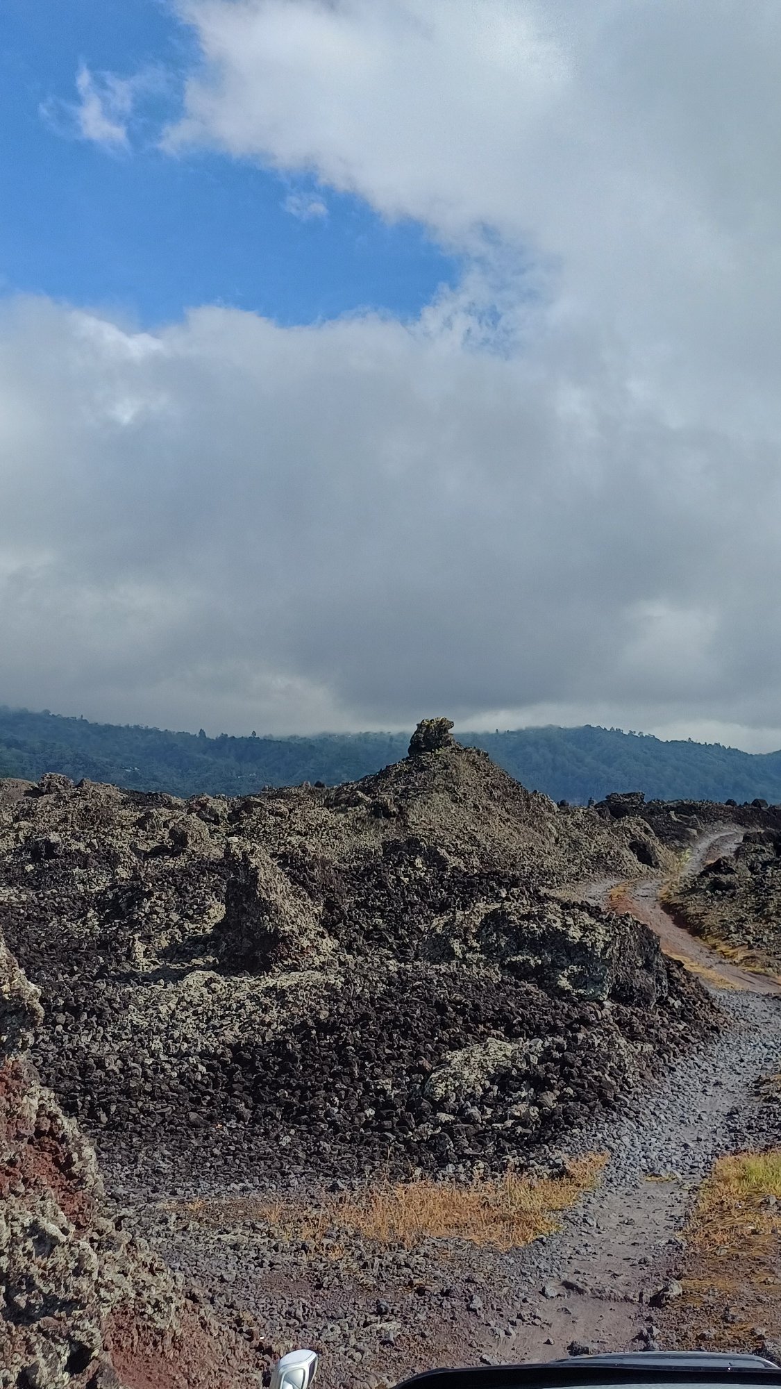 Tourist documents volcanic landscape tour in Kintamani, Indonesia