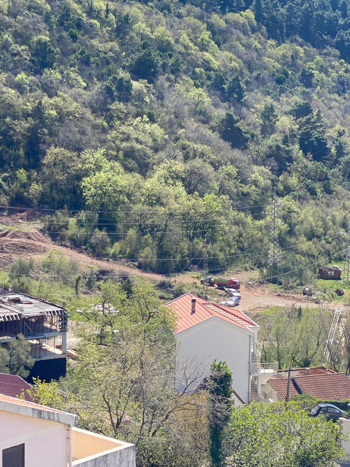 Budva Montenegro hillside construction activity observed April morning